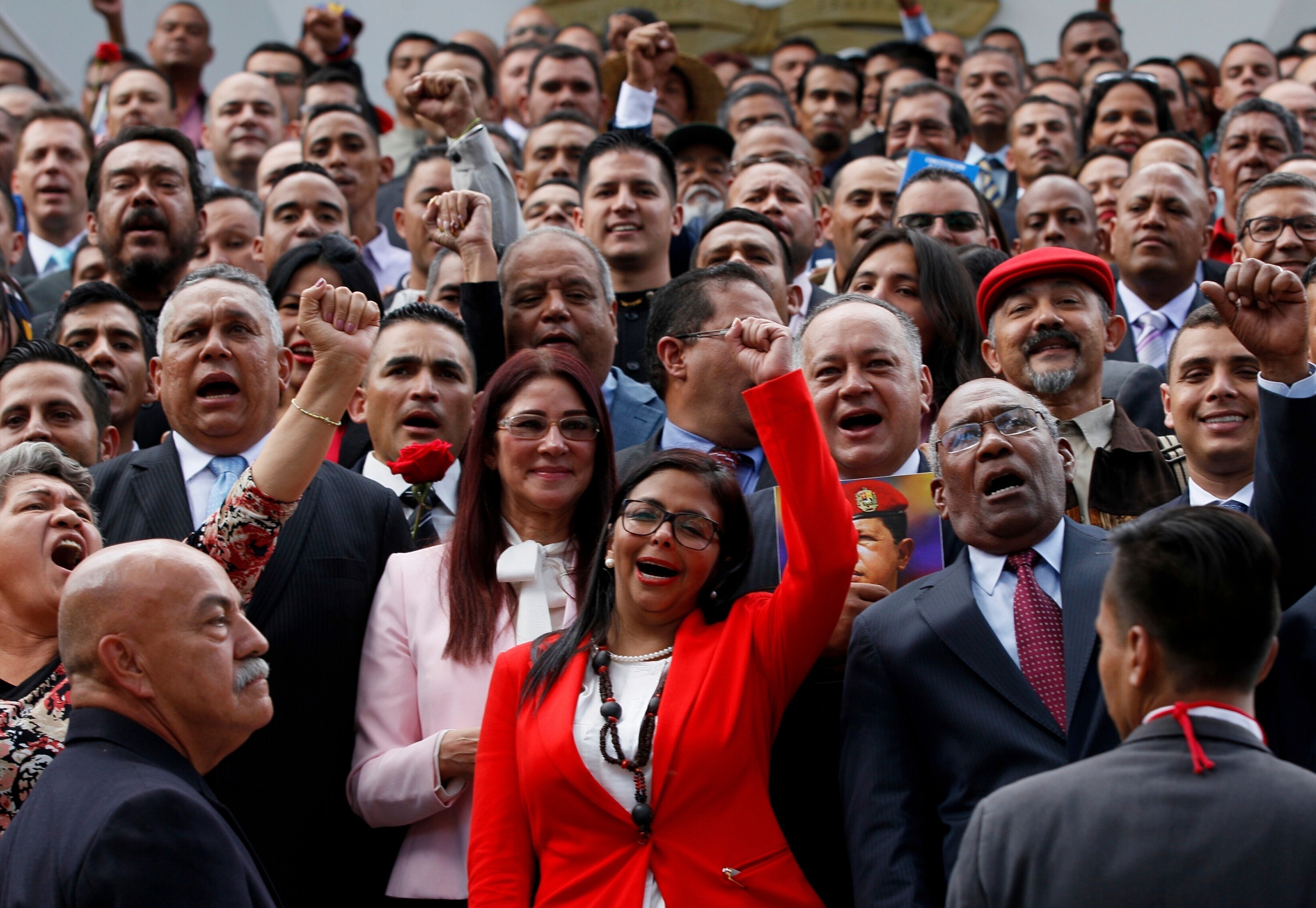 FILE - President of the new Constituent Assembly Delcy Rodriguez, in red, leads the newly sworn-in members as they pose for an official photo, in Caracas, Venezuela, Aug. 4, 2017. (AP Photo/Ariana Cubillos, File)