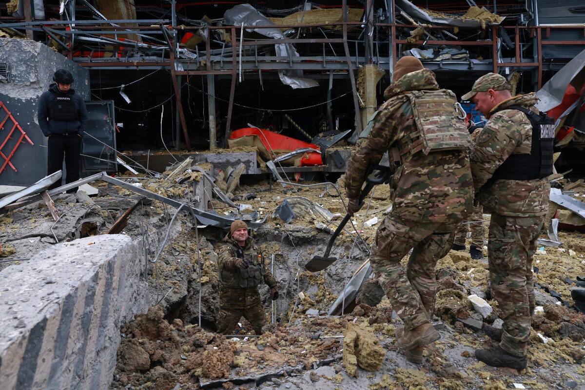 Sappers examine the site of a Russian missile strike which hit a post office storehouse in Zaporizhzhia, Ukraine, Tuesday, March 17, 2026. (AP Photo/Kateryna Klochko)