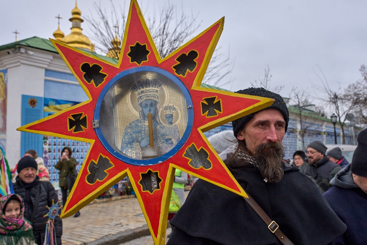 A man wearing a traditional costume celebrates Christmas near St. Michael Monastery in the city center of Kyiv, Ukraine, Thursday, Dec. 25, 2025. (AP Photo/Efrem Lukatsky)