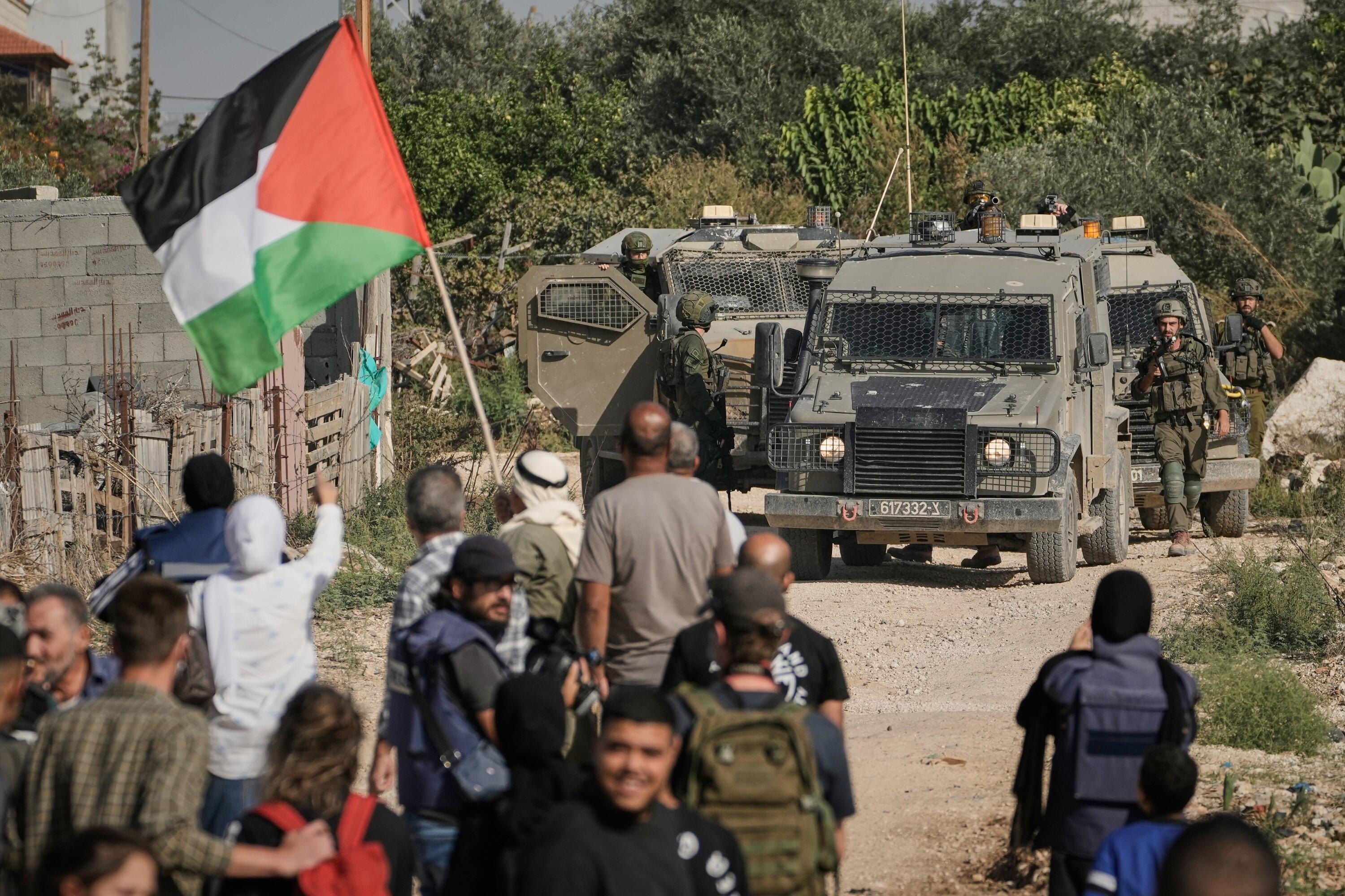 Israeli soldiers disperse protesters calling for the return of displaced Palestinians to their homes in the Nur Shams refugee camp, in the West Bank city of Tulkarem, Sunday, Nov. 23, 2025. (AP Photo/Majdi Mohammed)