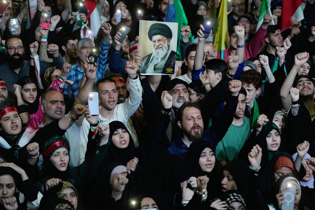 Pro-government demonstrators chant slogans as one of them holds a picture of the slain Iranian Supreme Leader Ayatollah Ali Khamenei during their gathering at Enqelab-e-Eslami, or Islamic Revolution, square in Tehran, Iran, Monday, May 4, 2026. (AP Photo/Vahid Salemi)