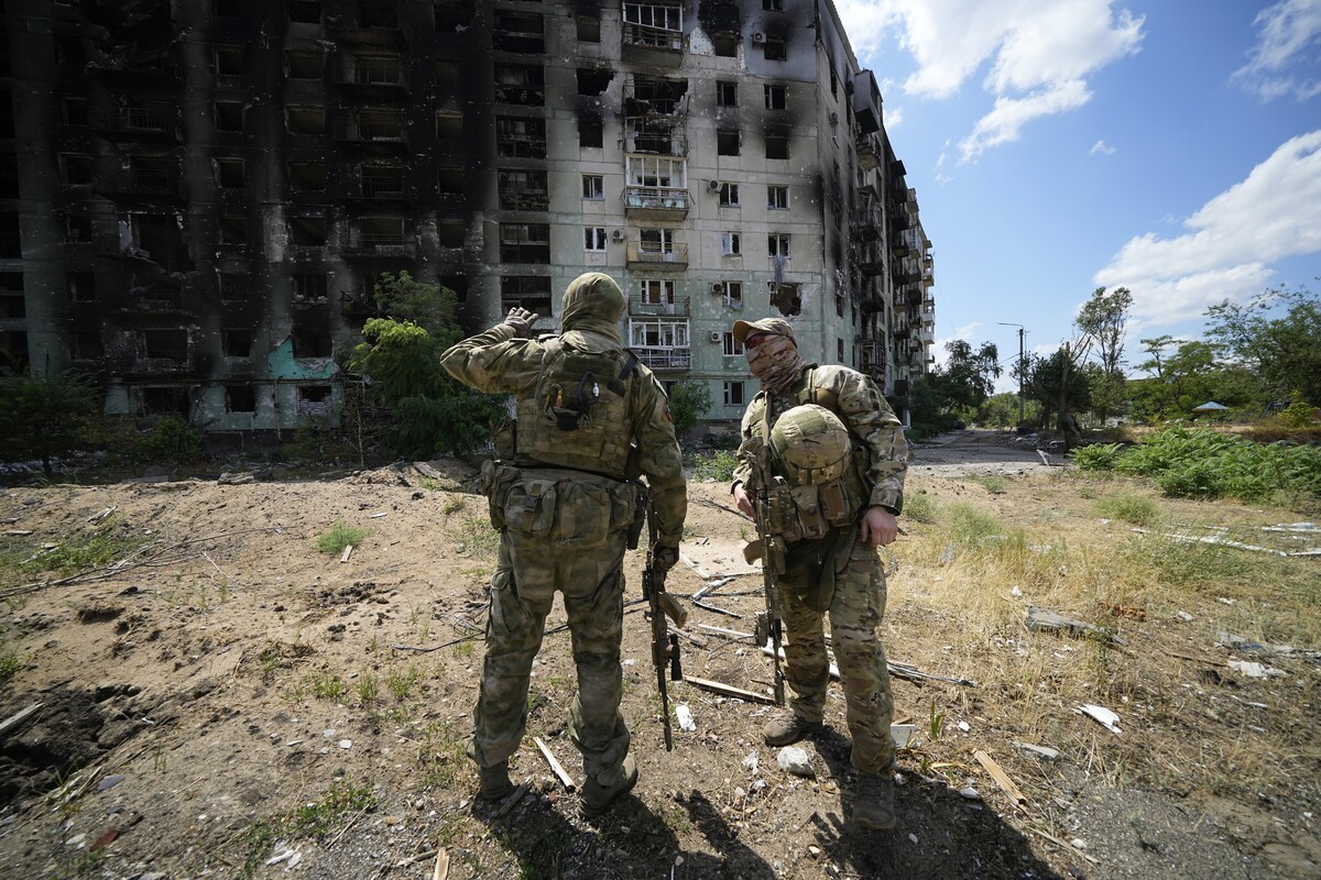 Russian soldiers talk to each other near an apartment building damaged during fighting between Russian and Ukrainian forces in Severodonetsk, on the territory which is under the Government of the Luhansk People's Republic control, eastern Ukraine, Tuesday, July 12, 2022. This photo was taken during a trip organized by the Russian Ministry of Defense. (AP Photo)