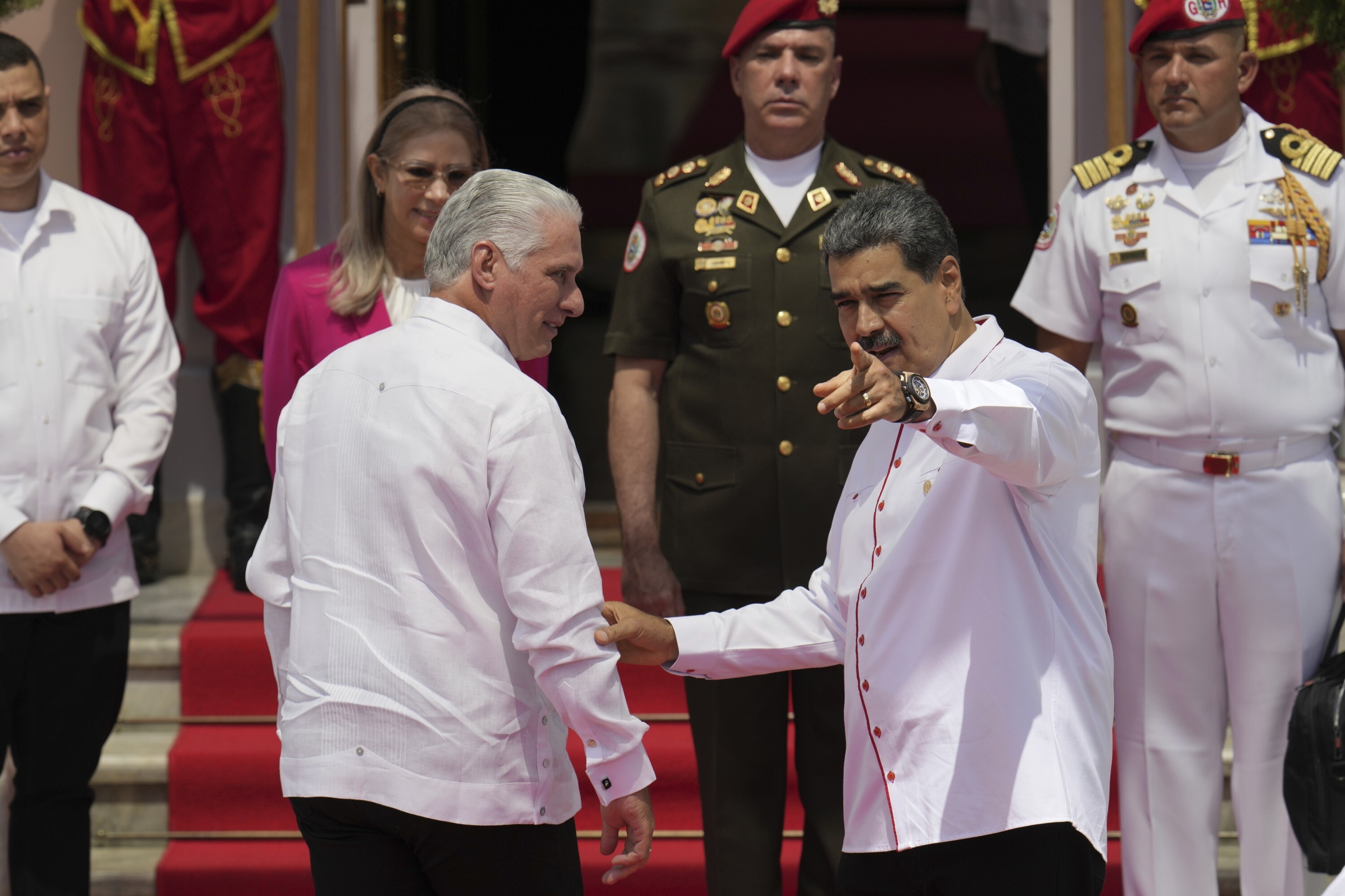 Venezuelan President Nicolas Maduro, right, and Cuba's President Miguel Diaz-Canel stand before photographers at the start of a summit by the Bolivarian Alliance for the Peoples of Our America (ALBA) at Miraflores presidential palace in Caracas, Venezuela, Wednesday, April 24, 2024. (AP Photo/Ariana Cubillos)