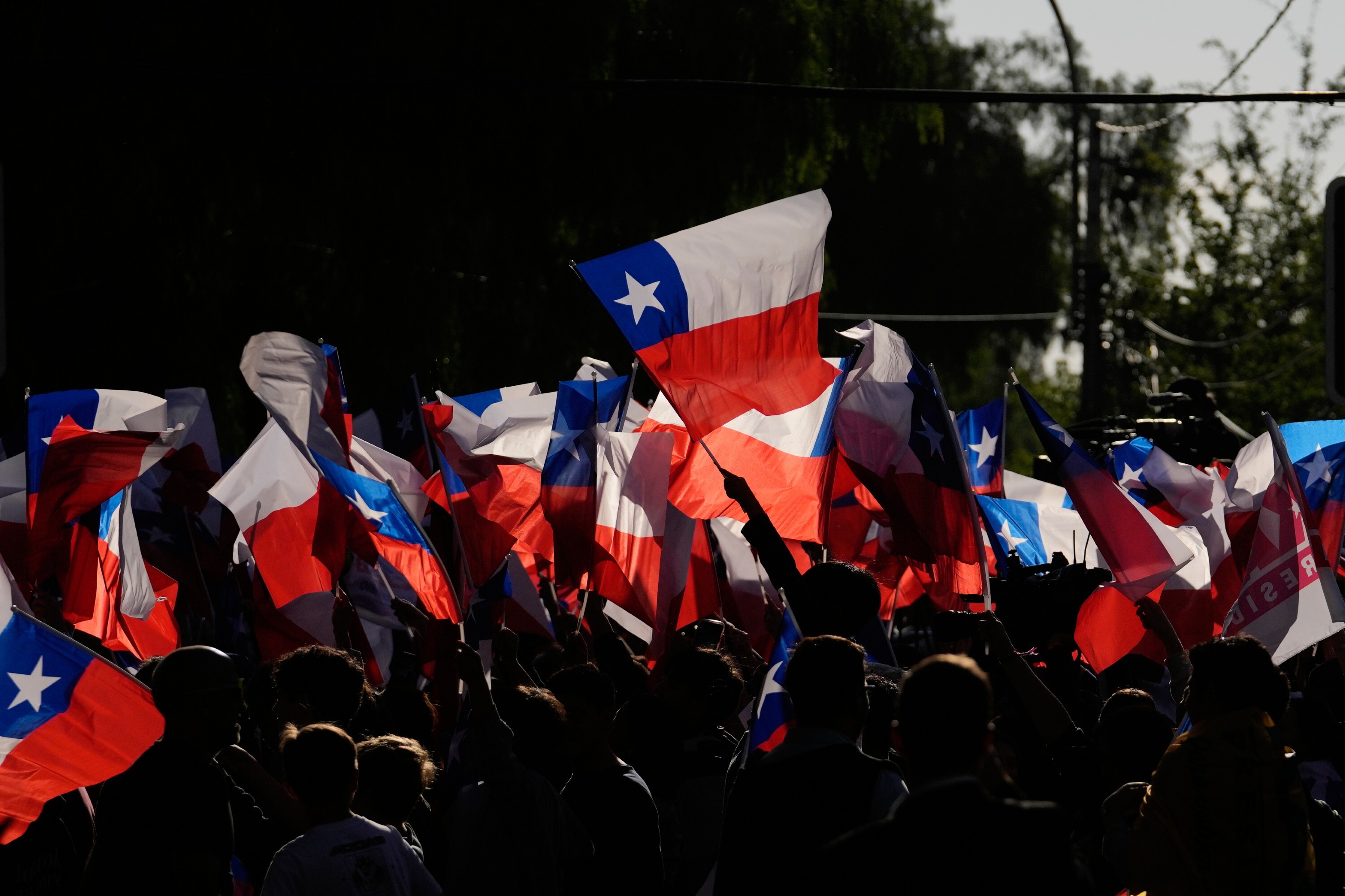 Supporters of Jose Antonio Kast, presidential candidate of the opposition Republican Party, celebrate preliminary results after polls closed for a presidential runoff election in Santiago, Chile, Sunday, Dec. 14, 2025. (AP Photo/Esteban Felix)