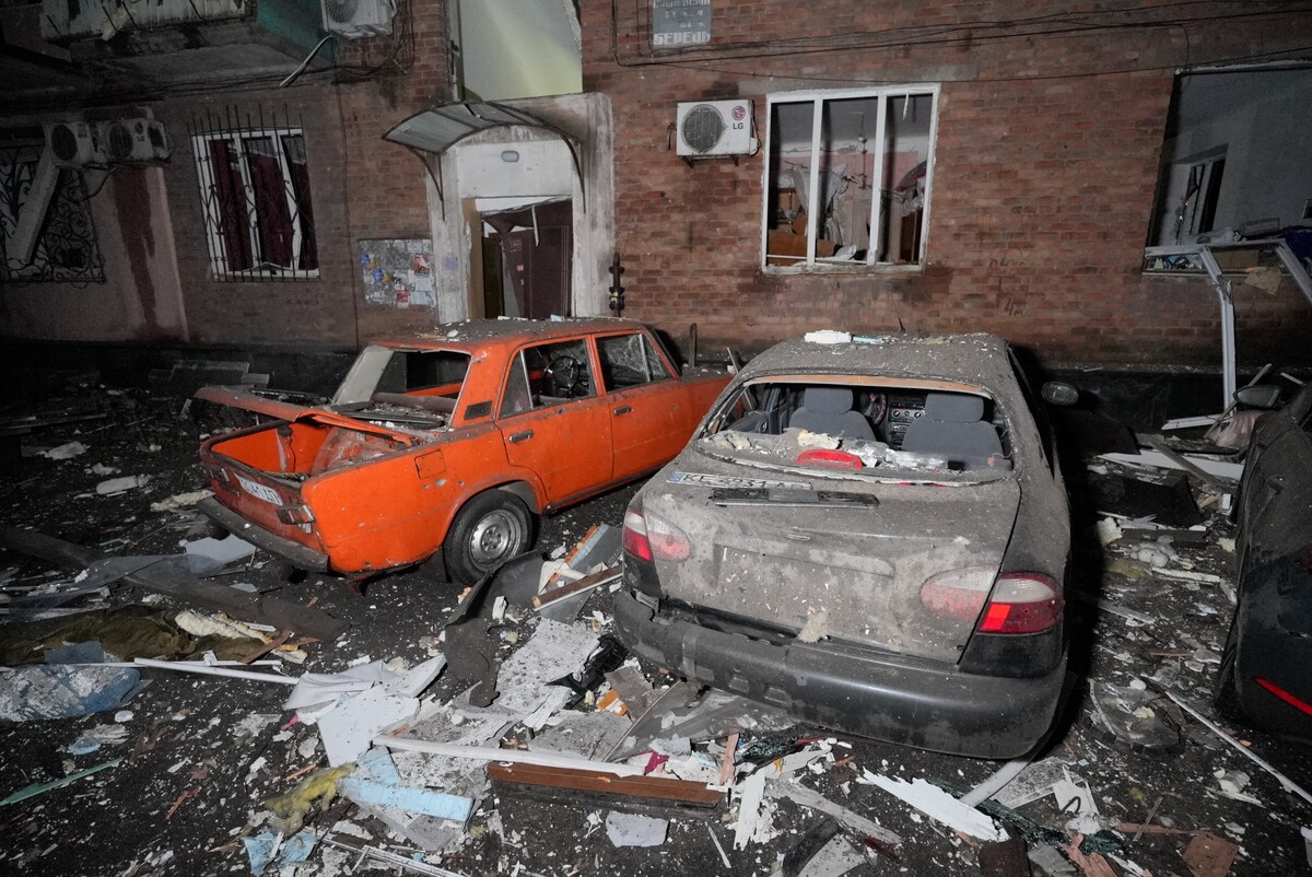 Cars damaged during a Russian strike sit parked amid debris in Kryvyi Rih, Ukraine, Thursday, Jan. 8, 2026. (AP Photo/Mykola Myrnyi)