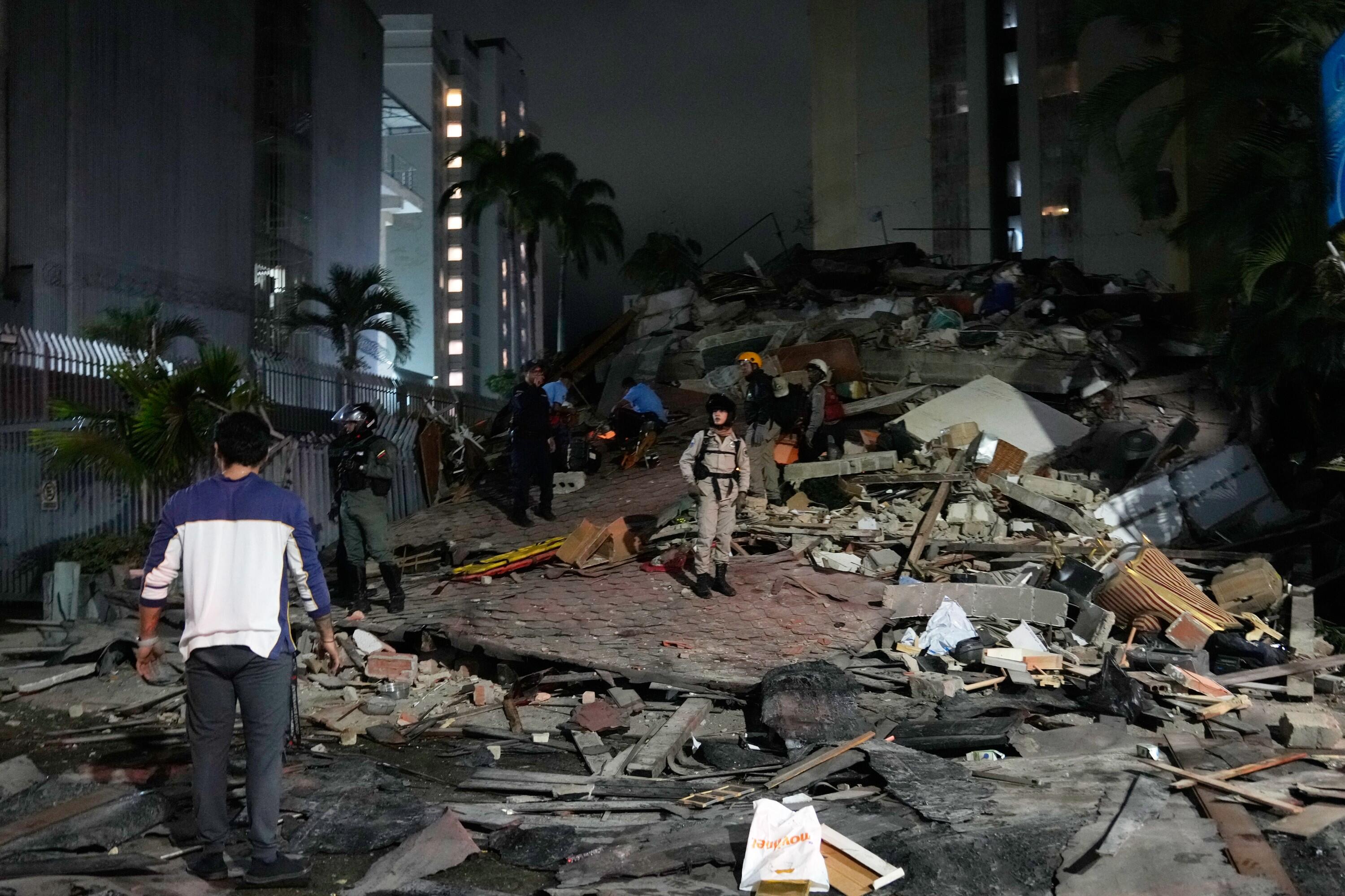 People walk amid debris after an earthquake in Caracas, Venezuela, Wednesday, June 24, 2026. (AP Photo/Ariana Cubillos)