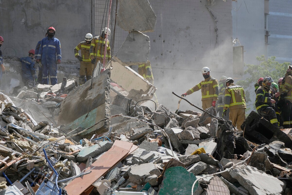 Rescuers clear the rubble after a Russian missile hit an apartment building during massive air attack in Kyiv, Ukraine, Thursday, May 14, 2026. (AP Photo/Efrem Lukatsky)