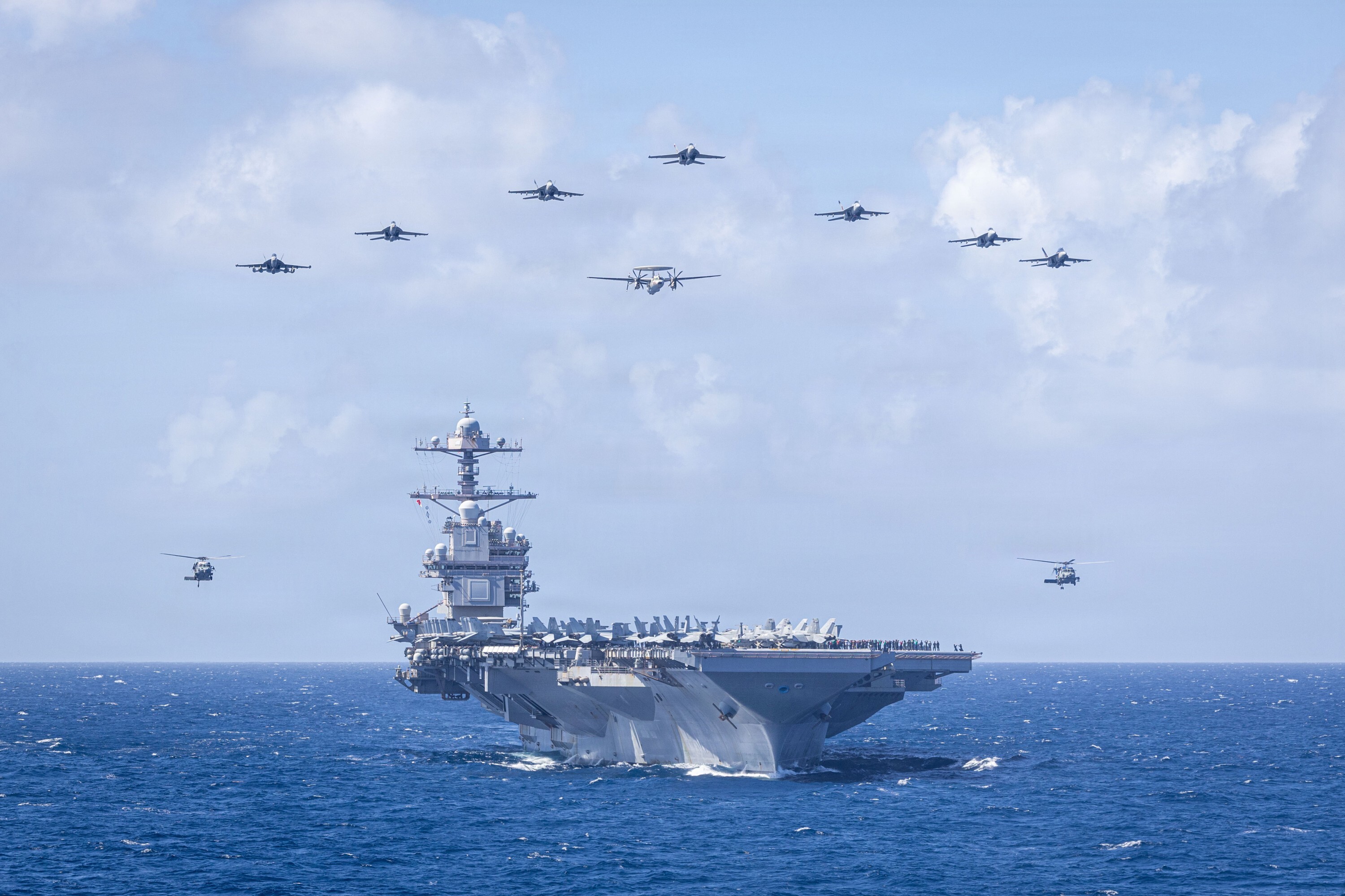 U.S. Navy Carrier Air Wing 8 aircraft fly in formation over the worlds largest aircraft carrier, Ford-class aircraft carrier USS Gerald R. Ford (CVN 78), during Carrier Air Wing 8s aerial change of command ceremony while underway in the Caribbean Sea, Jan. 19, 2026. U.S. military forces are deployed to the Caribbean in support of the U.S. Southern Command mission, Department of War-directed operations, and the presidents priorities to disrupt illicit drug trafficking and protect the homeland. (U.S. Navy photo)