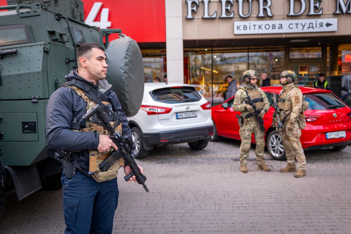 Police officers are seen at the site where a gunman killed at least six people in the streets before being shot dead by police, in Kyiv, Ukraine, Saturday, April 18, 2026. (AP Photo/Dan Bashakov)
