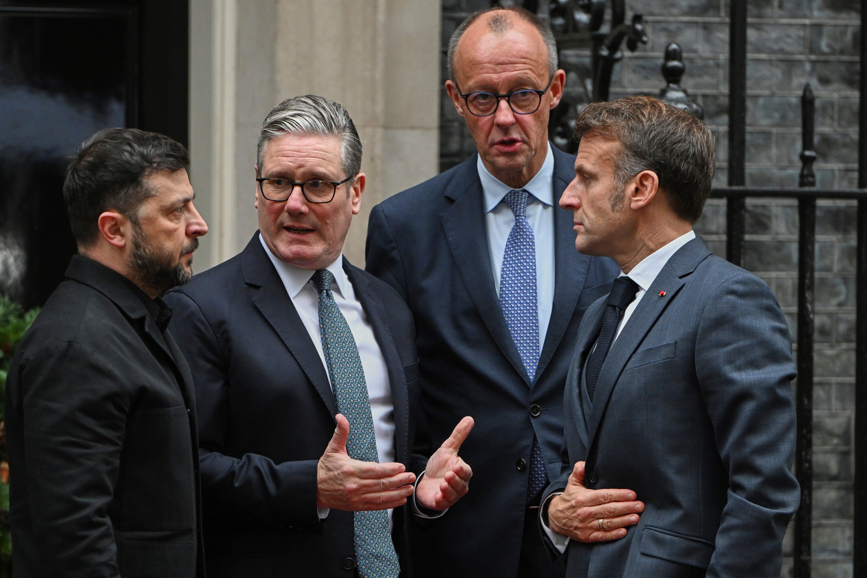 Ukrainian President Volodymyr Zelenskyy, left, with Britain's Prime Minister Keir Starmer, German Chancellor Friedrich Merz, and French President Emmanuel Macron, talk on the doorstep of 10 Downing Street, London, Monday, Dec. 8, 2025, following a meeting of the leaders inside. (AP Photo/Thomas Krych)