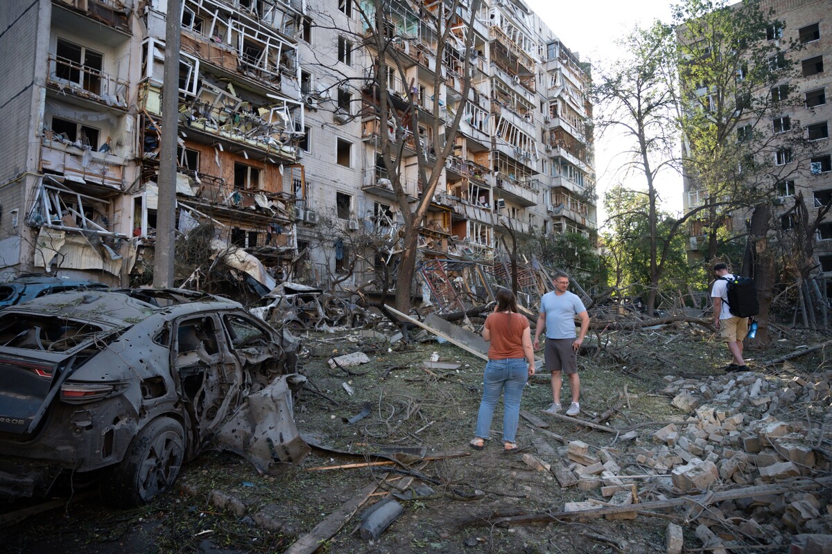 People look at a residential building damaged during the Russian missile attack in Kyiv, Ukraine, Thursday, July 2, 2026. (AP Photo/Danylo Antoniuk)