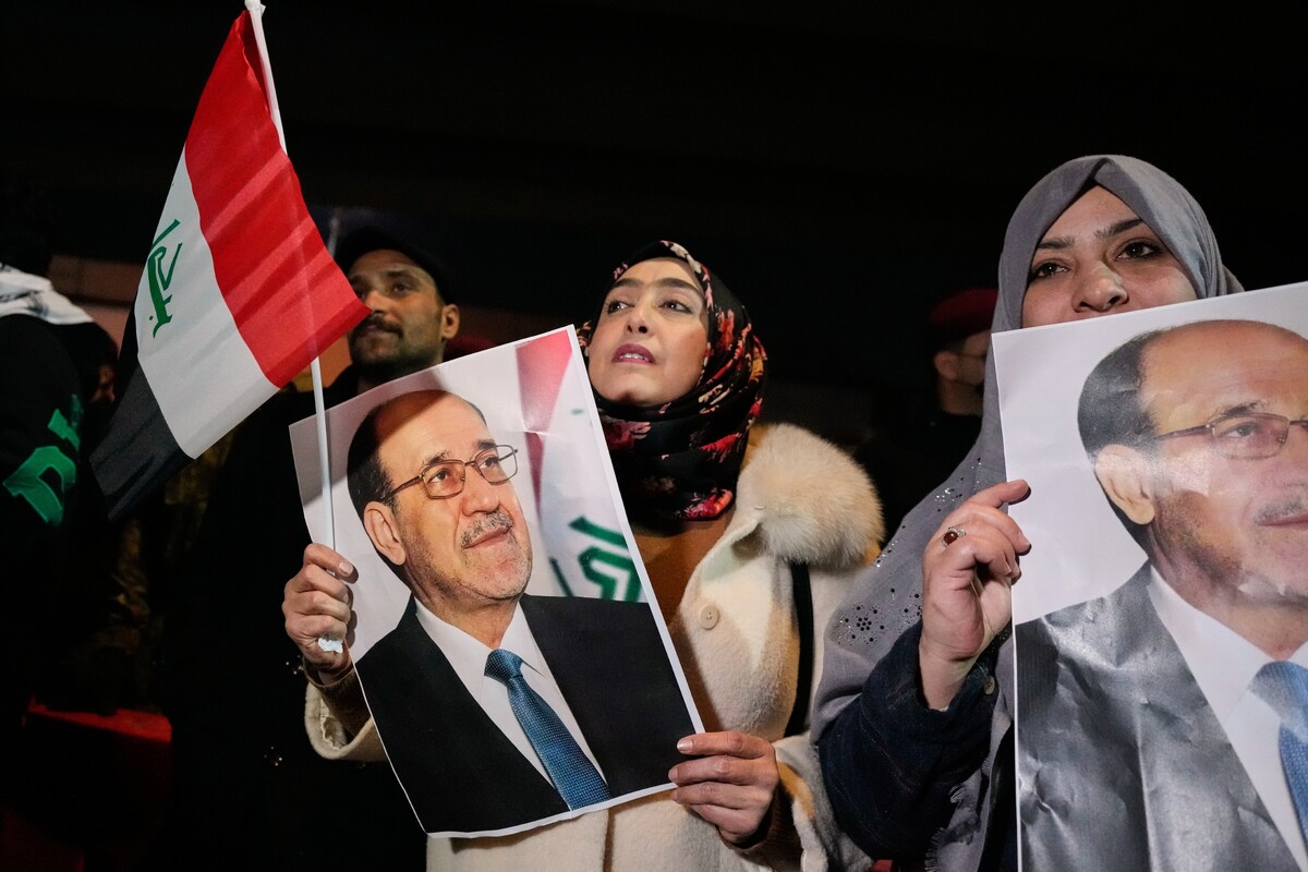 Women hold portraits of former prime minister, Nouri al-Maliki, during a protest against President Donald Trump at a bridge leading to the fortified Green Zone where the U.S. Embassy is located in Baghdad, Iraq, Thursday, Jan. 29, 2026. (AP Photo/Hadi Mizban)
