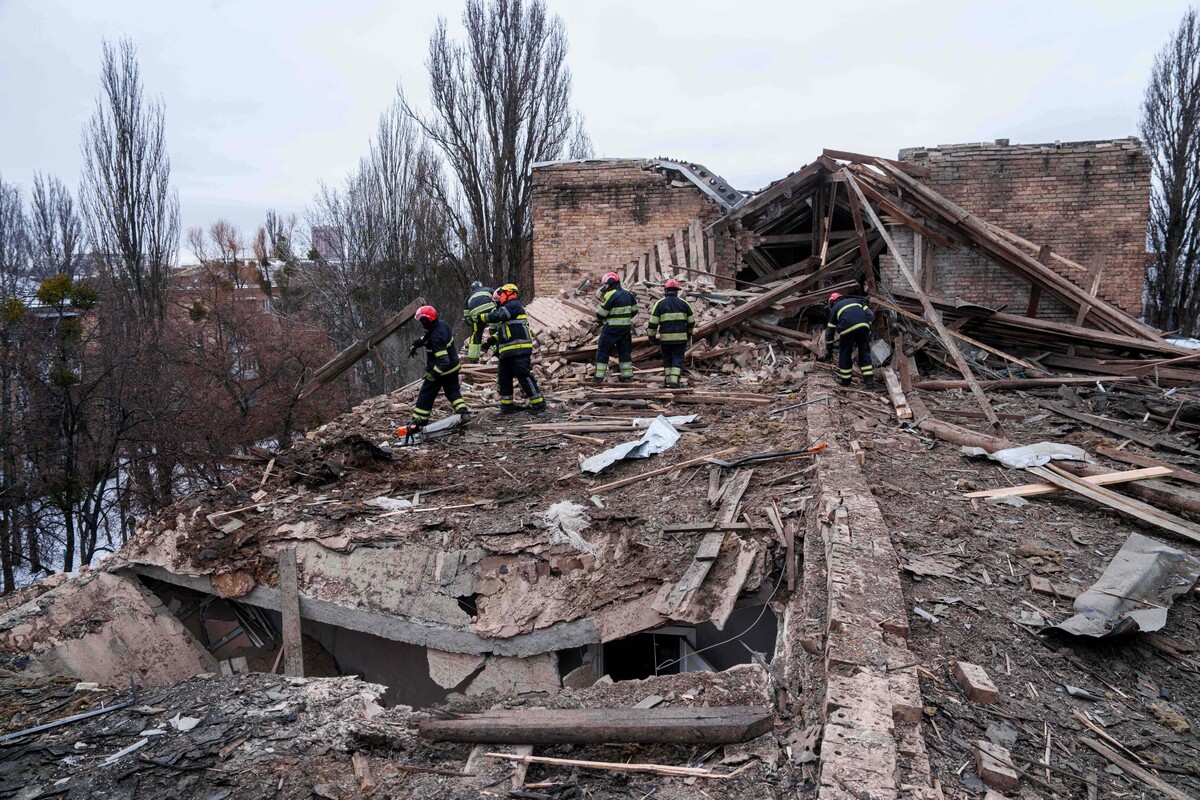 Rescue workers clear the rubble at the roof of apartment building damaged after a Russian strike on Kyiv, Ukraine, on Saturday, Dec. 27, 2025. (AP Photo/Evgeniy Maloletka)
