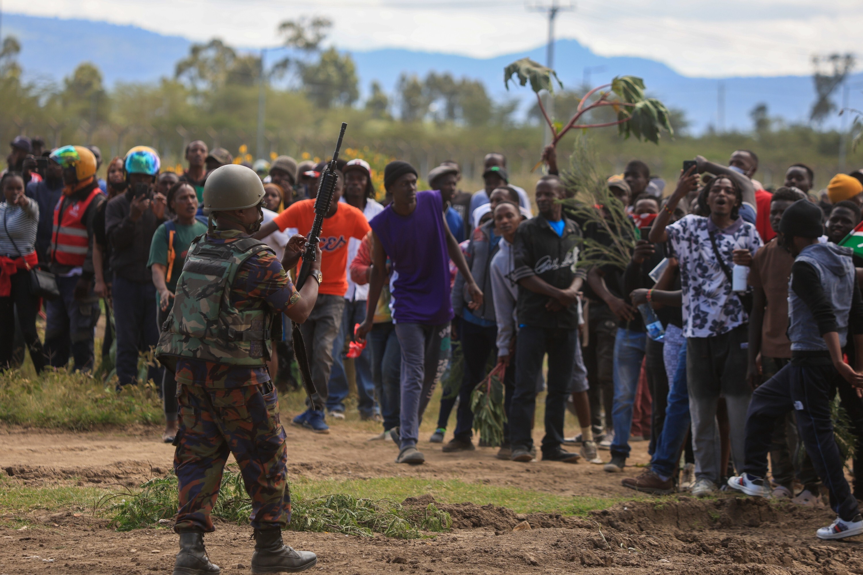 A Kenyan army soldier cocks his weapon as protesters demonstrate against a proposed Ebola quarantine center to be established by the United States at Laikipia Air Base in Nanyuki, Kenya, Monday, June 1, 2026. (AP Photo/Andrew Kasuku)