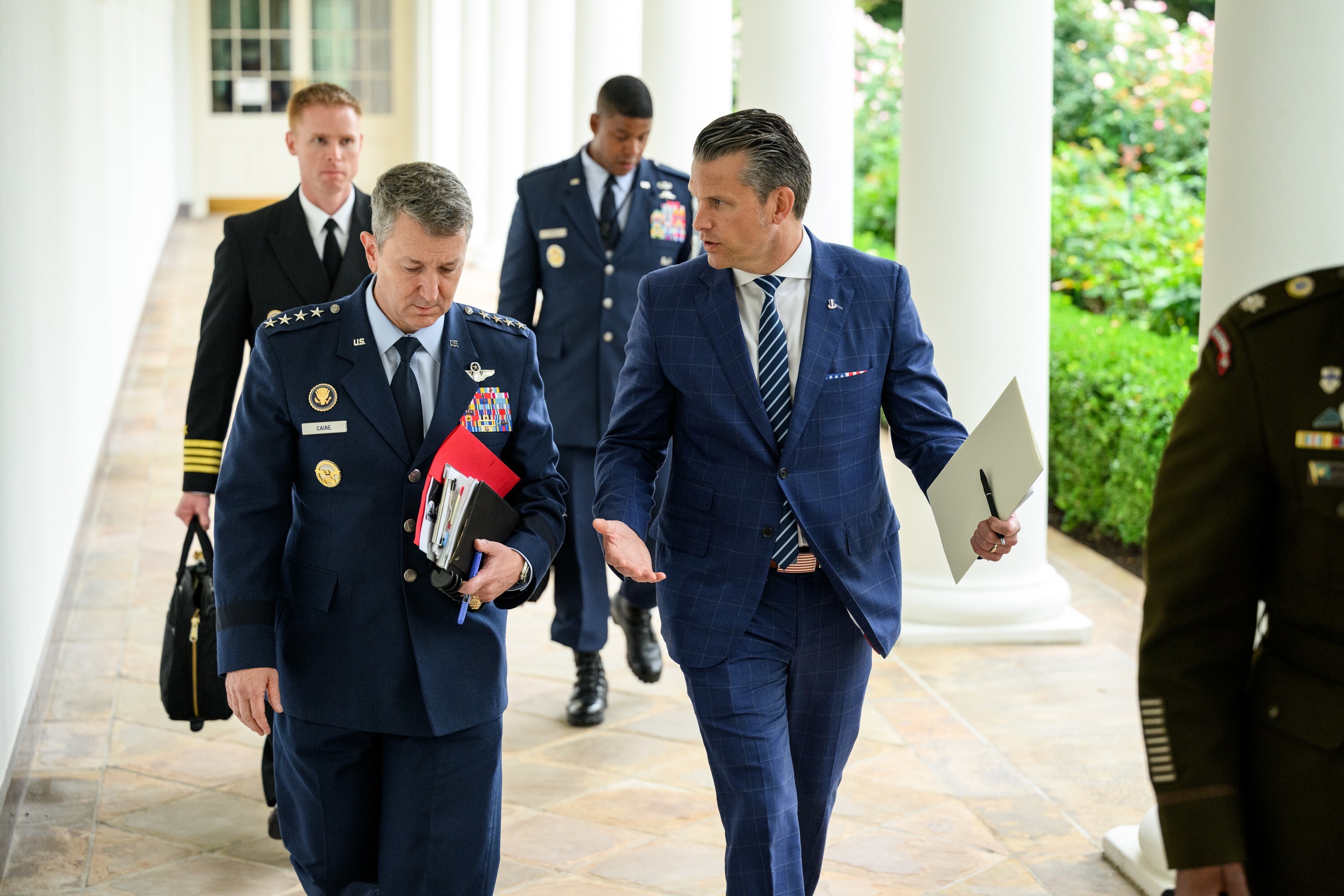 Chairman of the Joint Chiefs of Staff Dan Caine and Secretary of Defense Pete Hegseth walk on the West Colonnade after President Donald Trumps unilateral meeting with President Volodymyr Zelenskyy of Ukraine and European leaders, Monday, August 18, 2025. (Official White House Photo by Molly Riley)